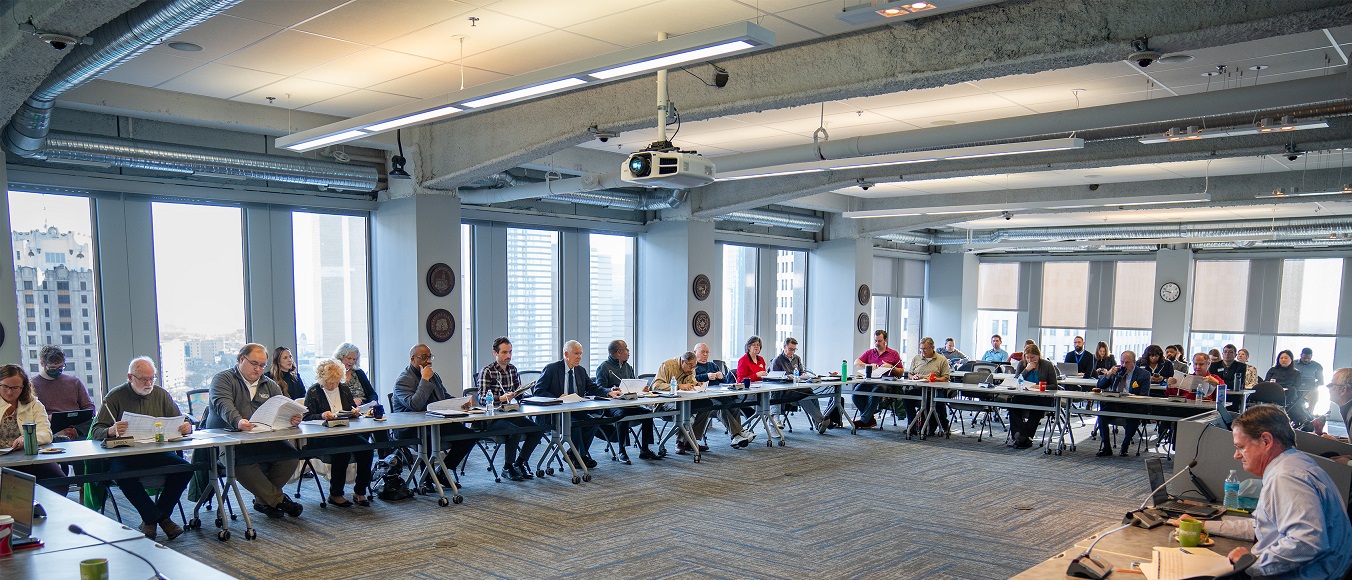 Group of people gathered around tables for meeting